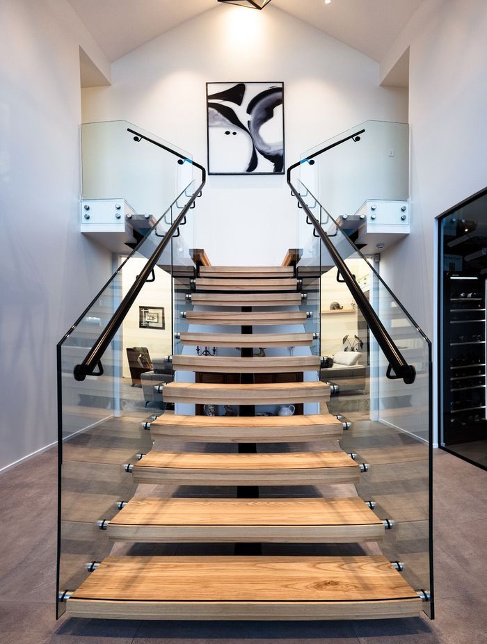 Floating timber stair treads add texture and warmth to the foyer area.