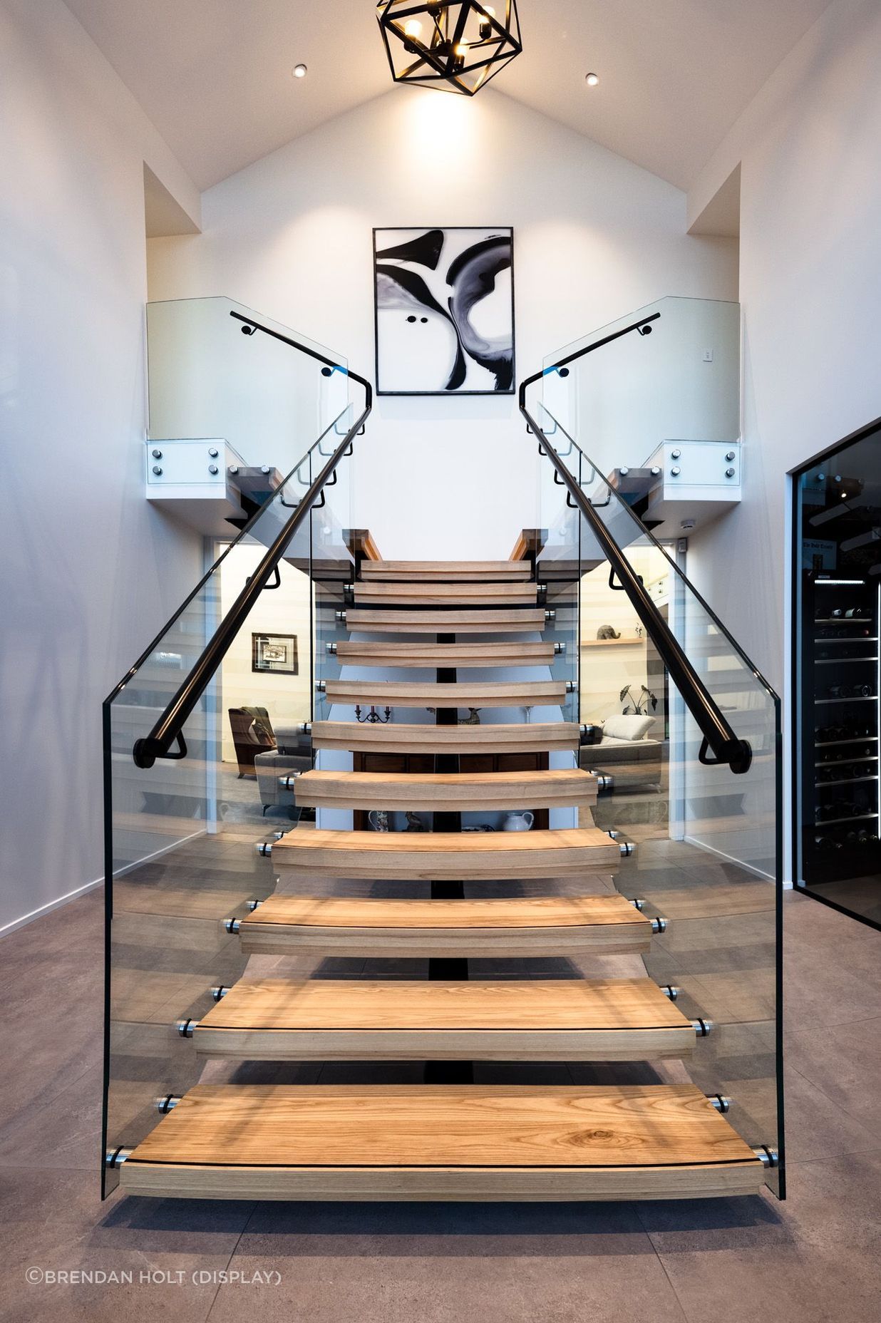 Floating timber stair treads add texture and warmth to the foyer area.