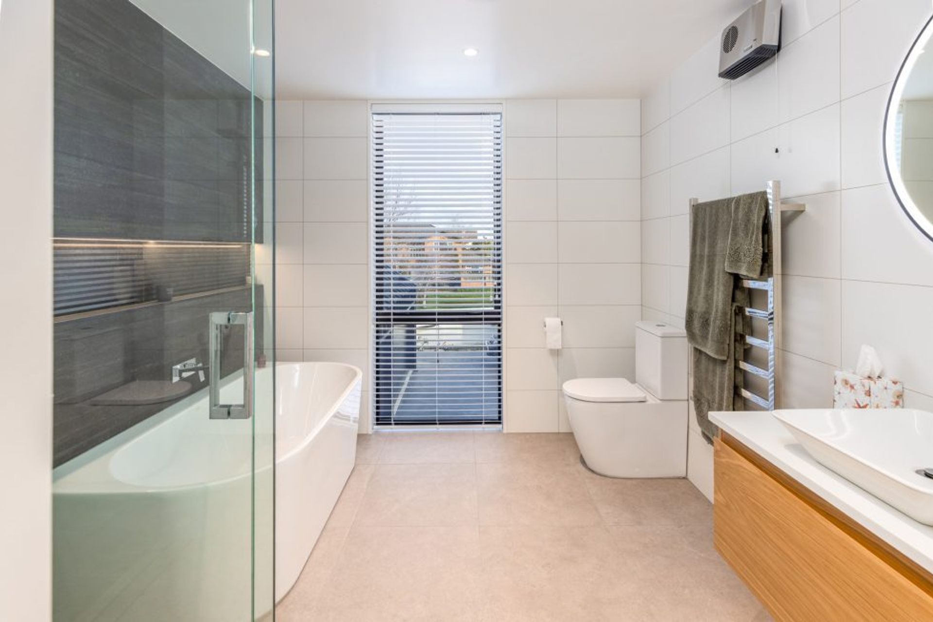 A resort-like aesthetic has been created in the bathrooms with natural tones and textures.