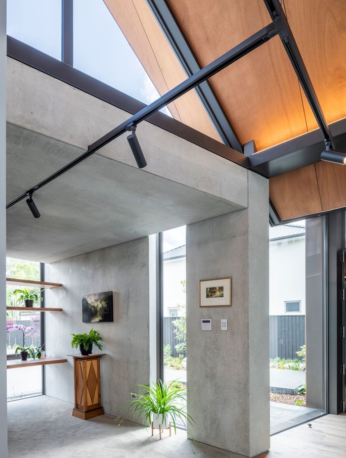 Lighting in the entry was designed to highlight art pieces and to have very minimal contact with the ceiling, says Craig.