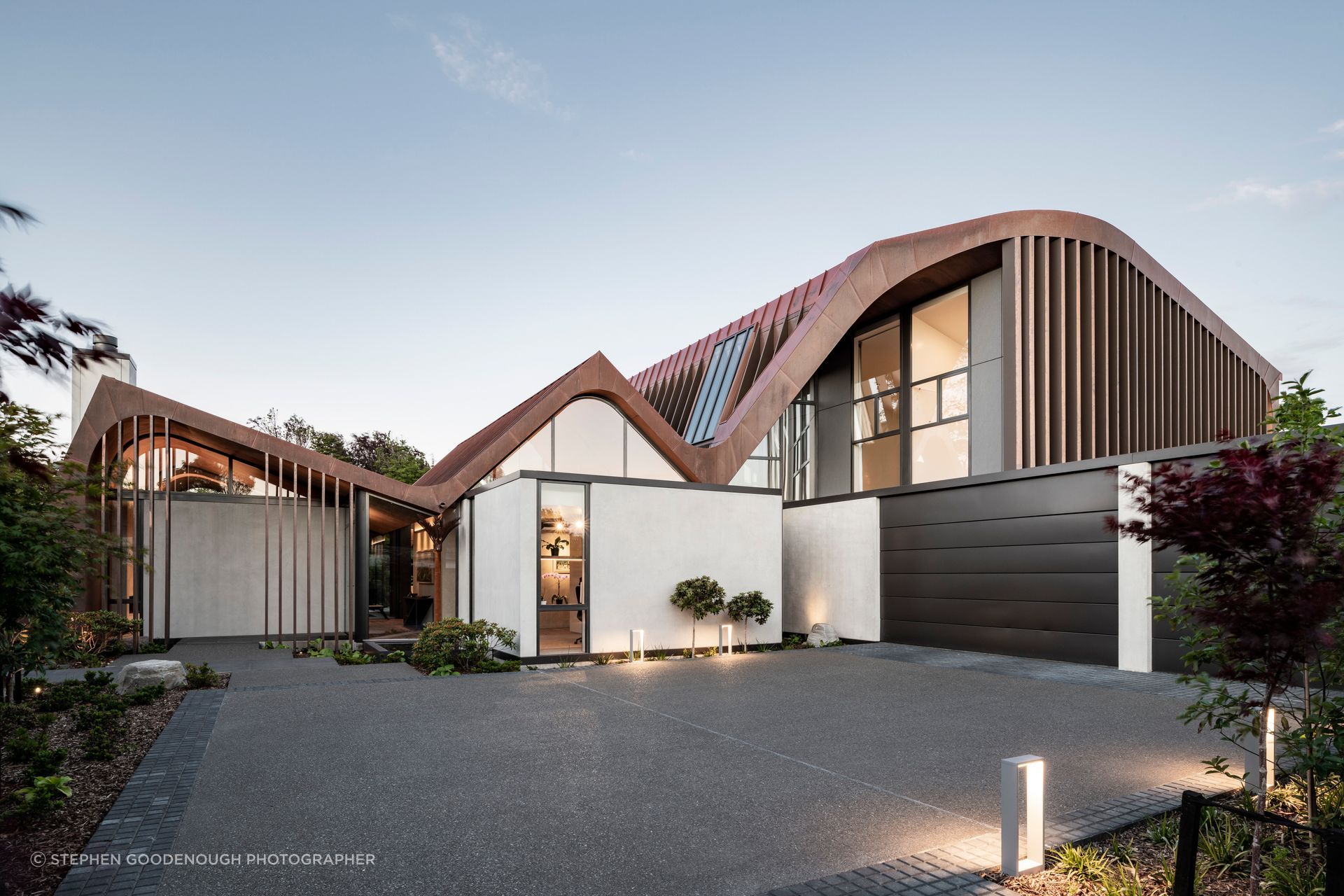 The new home for a retired couple by Craig South of South Architects in Christchurch. Design work was already underway when the homeowners suggested adding curves to the roofline. “The form changed slightly,” says Craig, “but the concept of the three concrete pavilions stayed.”