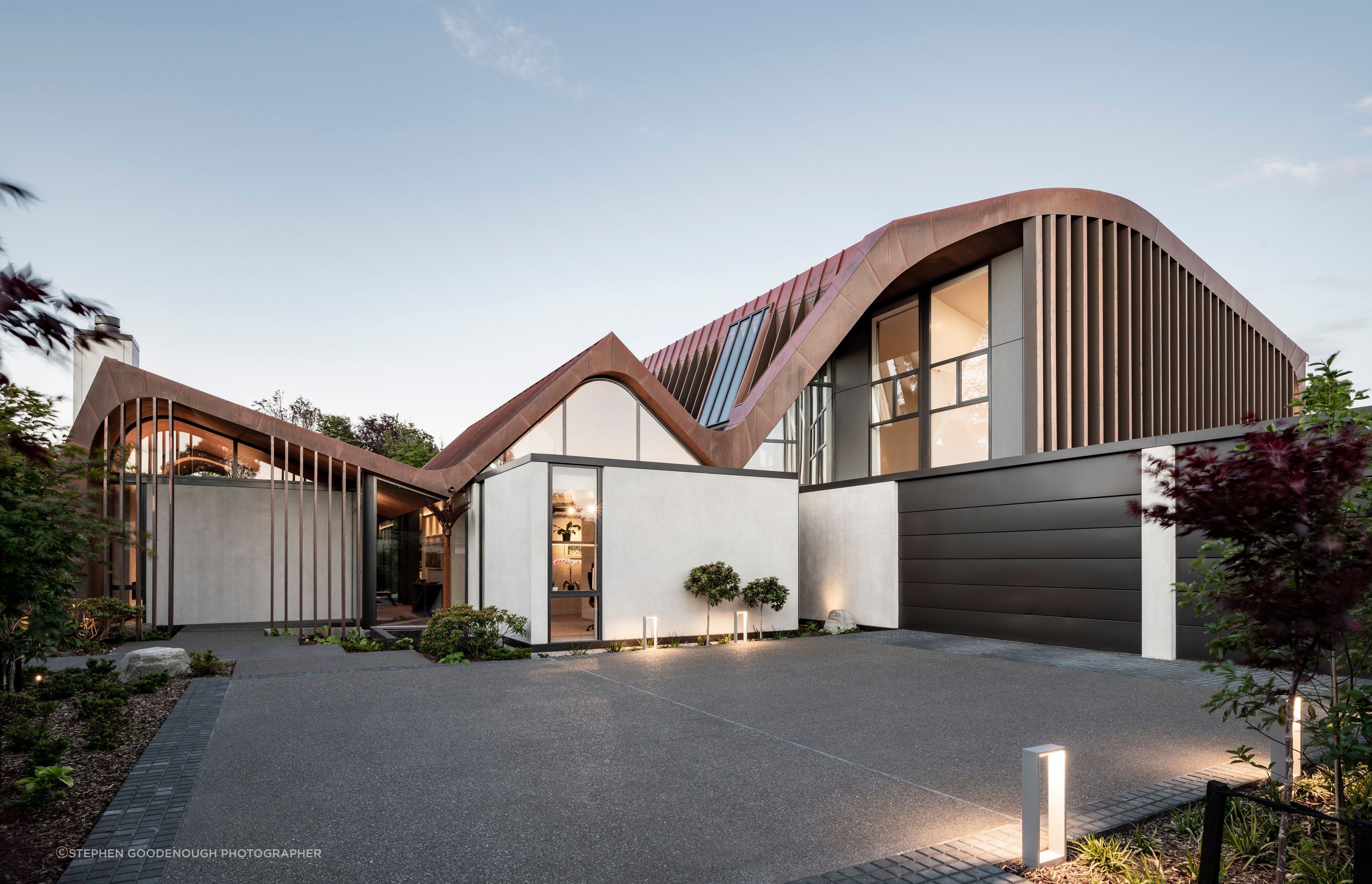 The new home for a retired couple by Craig South of South Architects in Christchurch. Design work was already underway when the homeowners suggested adding curves to the roofline. “The form changed slightly,” says Craig, “but the concept of the three concrete pavilions stayed.”