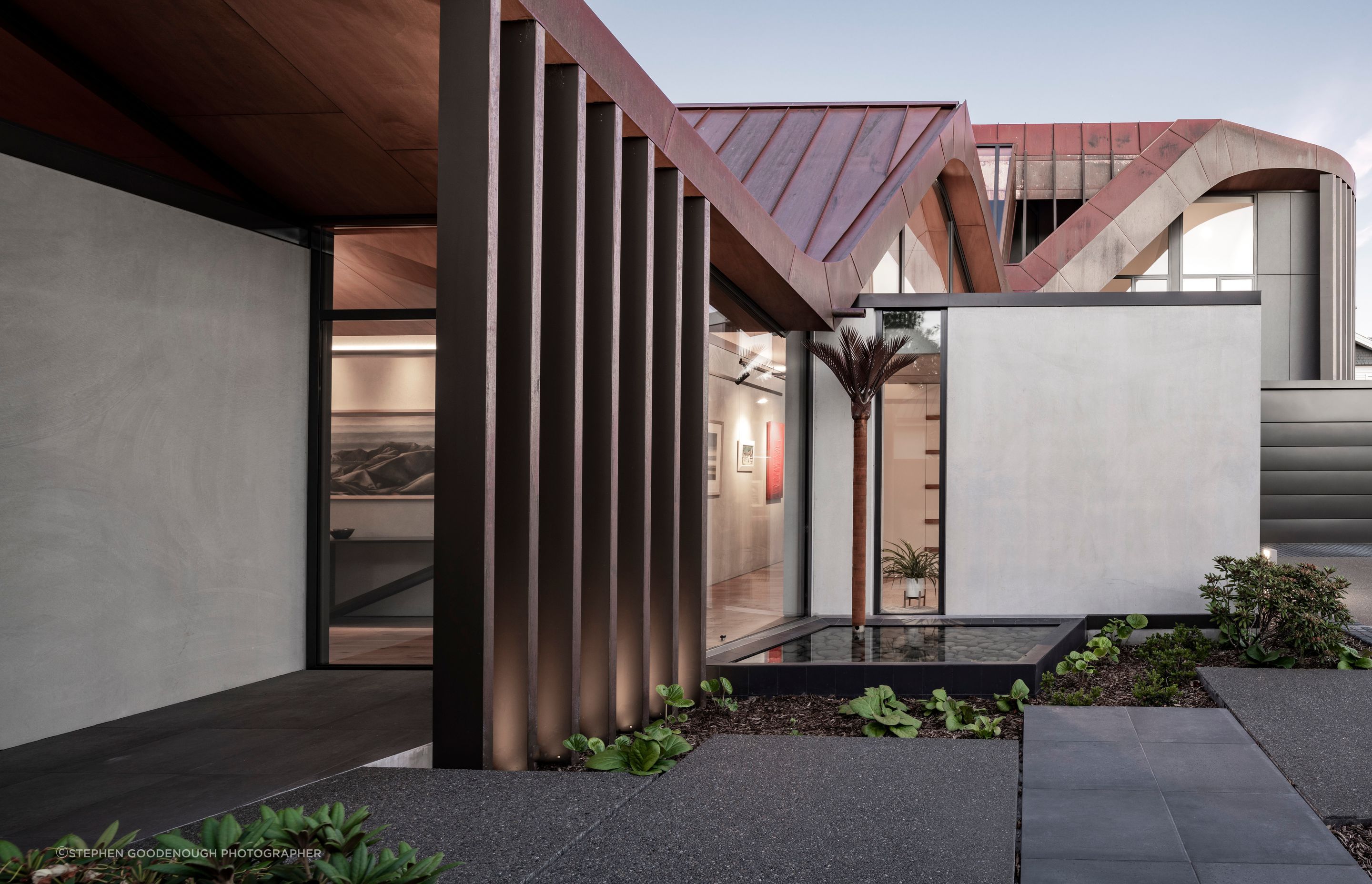 Very clever downpipes in the form of nīkau sculptures by Jane Downes preserve the shape of the roof.