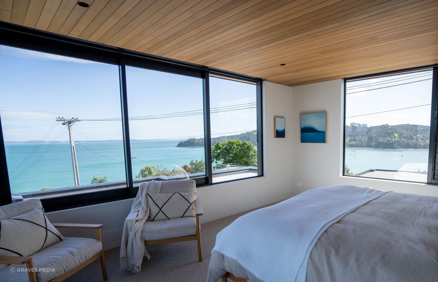 Large sliding windows welcome in the ocean breeze and furniture and textiles have been carefully selected to complement the cedar sarking and surrounding environment.