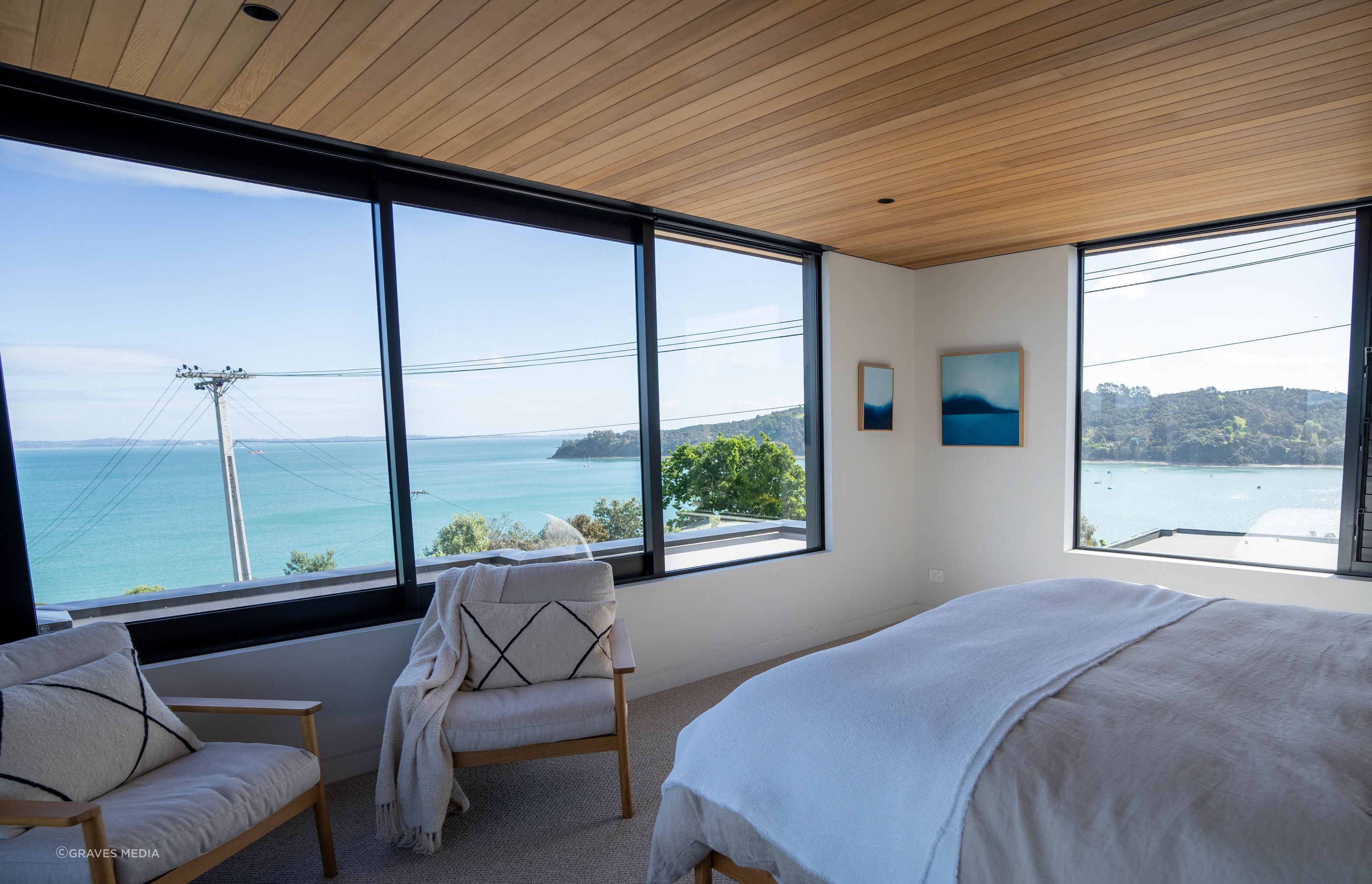 Large sliding windows welcome in the ocean breeze and furniture and textiles have been carefully selected to complement the cedar sarking and surrounding environment.
