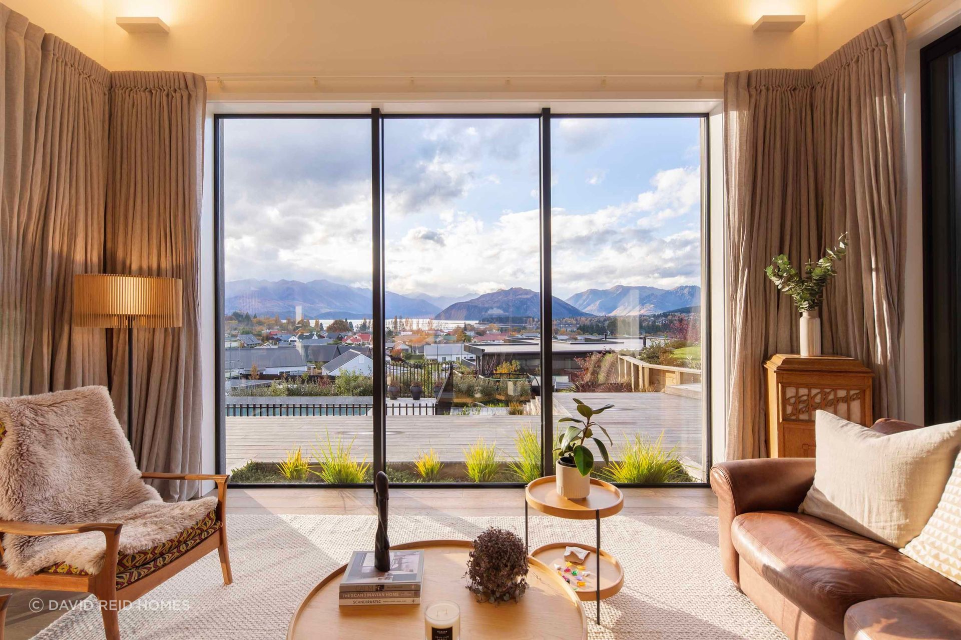 The step-down living room looks out over Lake Wānaka.