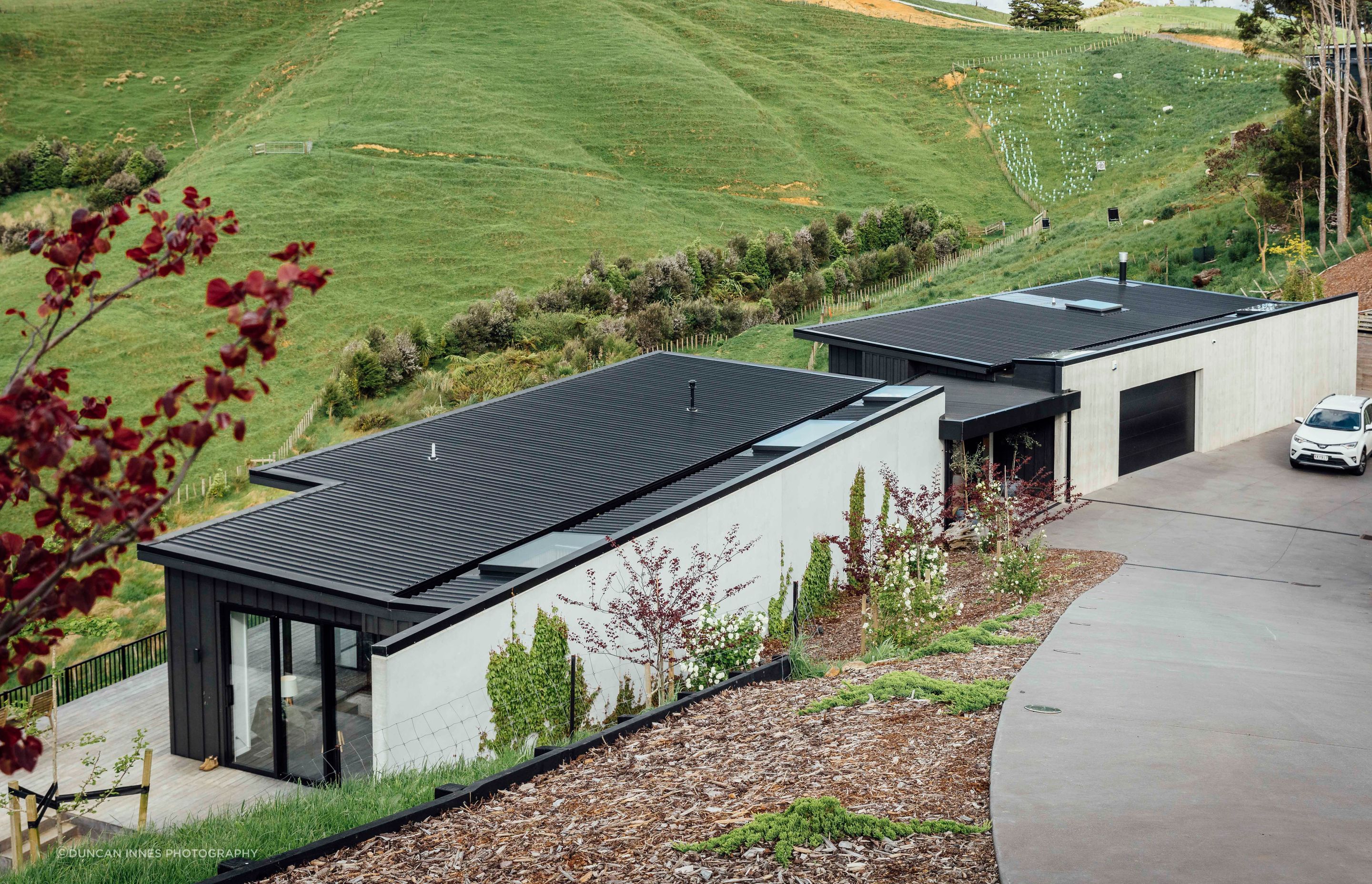 The house in Auckland’s Bombay Hills designed by Brendon Hamill of David Reid Homes in Pukekohe. The stunning outlook belies the complications of the site but there’s plenty of room for the homeowners’ sheep, pigs and chickens.