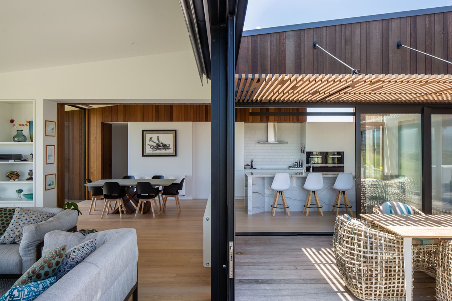 The living area, left, and the courtyard, right, with the kitchen and dining room beyond. The driftwood print has pride of place overlooking the dining table.