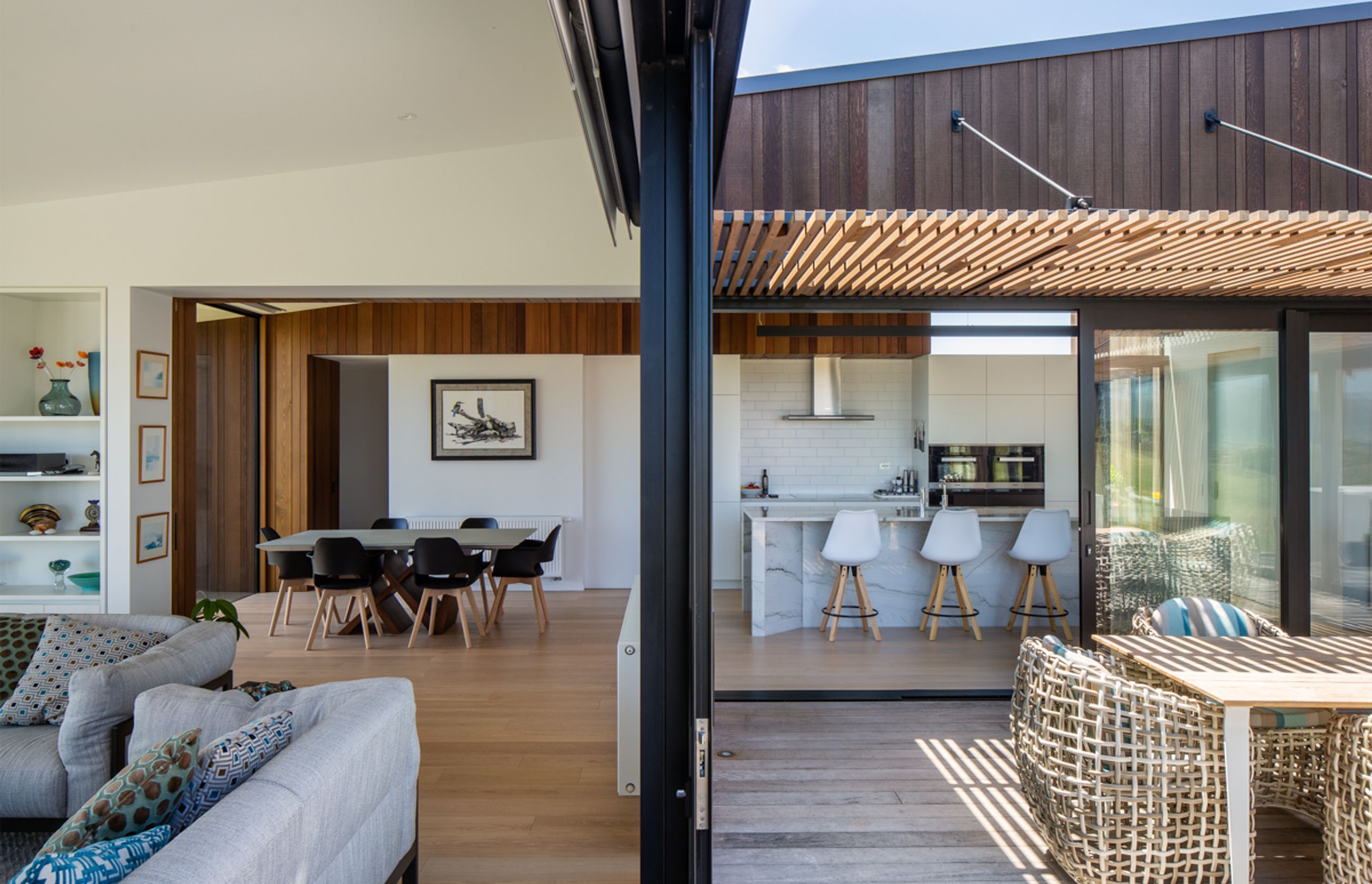 The living area, left, and the courtyard, right, with the kitchen and dining room beyond. The driftwood print has pride of place overlooking the dining table.