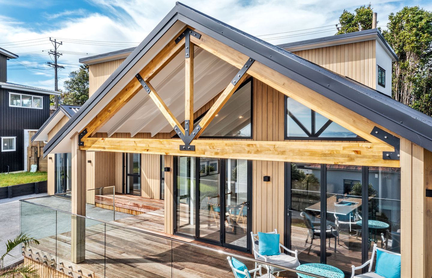 The Abodo Vulcan cladding complements the exposed timber trusses and kwila decking.
