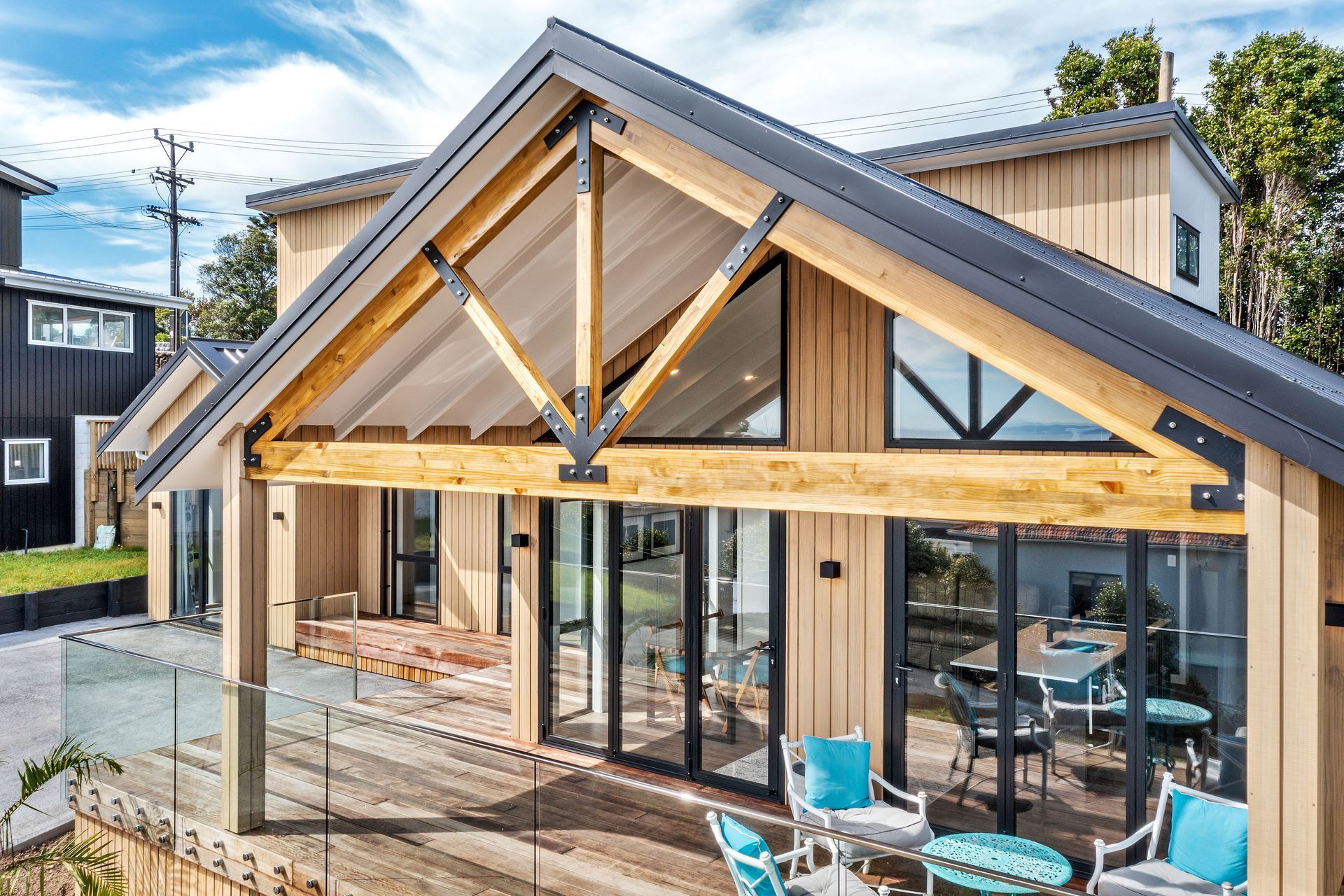 The Abodo Vulcan cladding complements the exposed timber trusses and kwila decking.