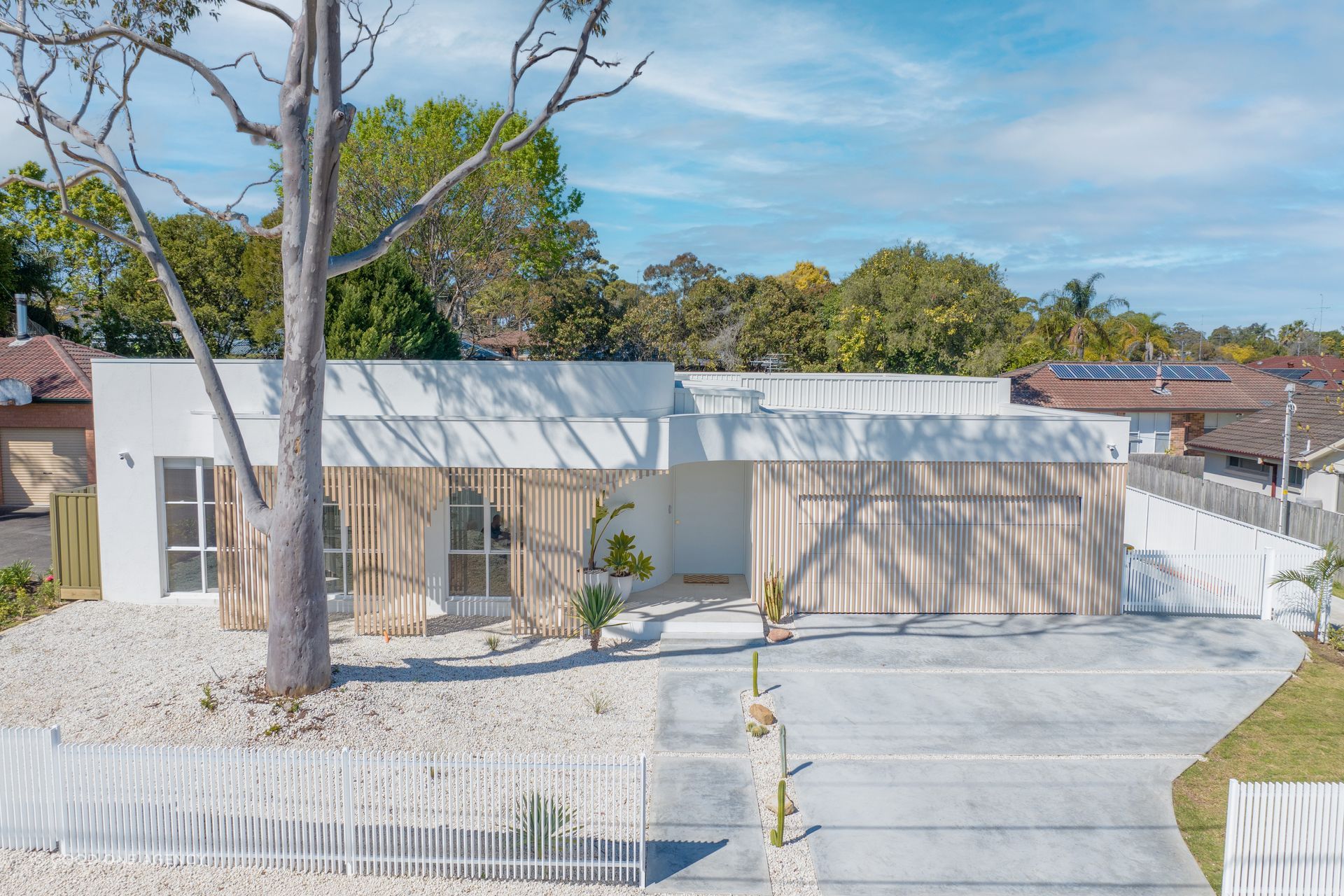 The pale exterior palette reflects the Mediterranean aesthetic.
