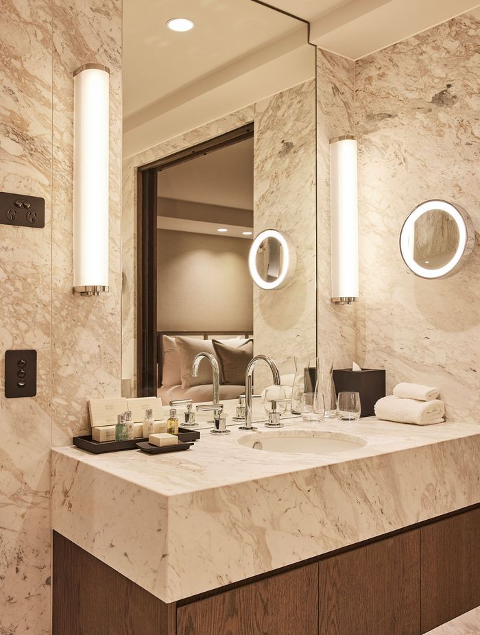 The hotel's rooms' ensuites are palatial in size and feature soft marble, contrasted against rich oak veneer.