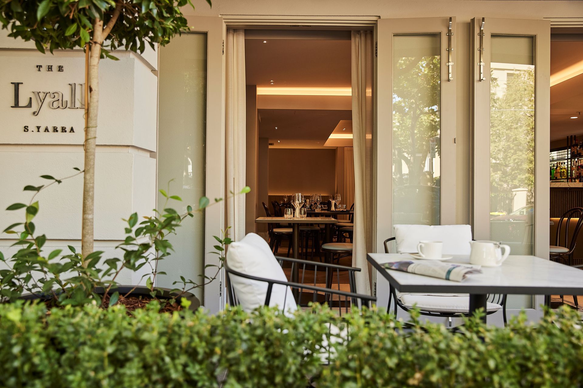 The entry to The Lyall passes by the al fresco dining area, leading guests into the soft lighting and serene colour palette that is the foundation of the luxurious yet cosy feeling throughout the hotel.