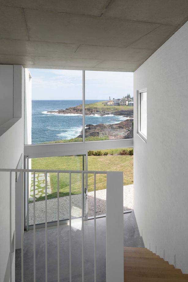 The double-height void allows light into the central living spaces from the street front side of the home.