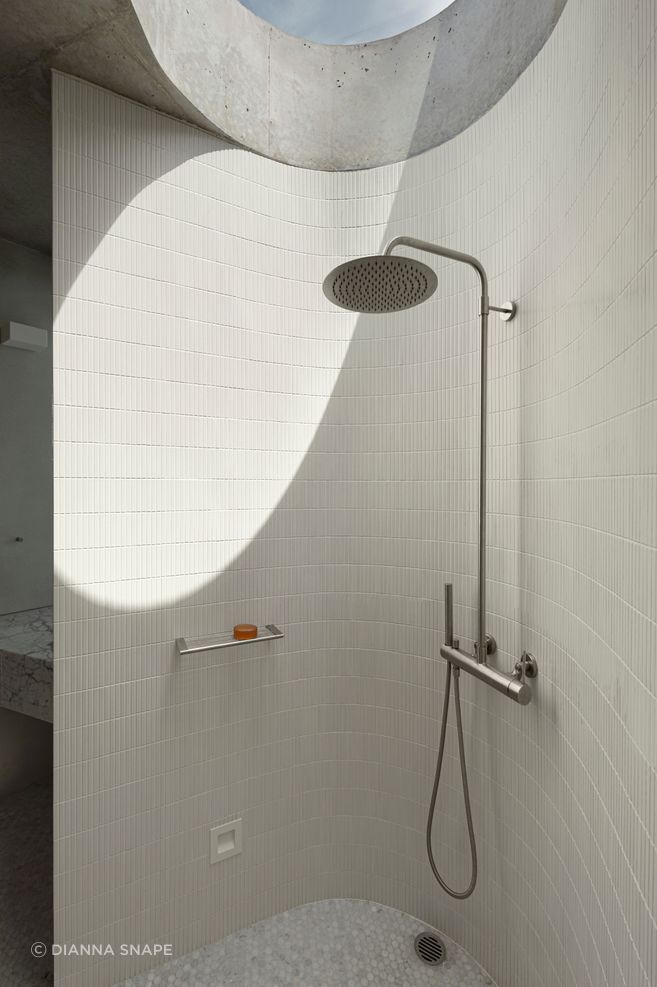 The curves of the shower room are echoed in the circular skylight.
