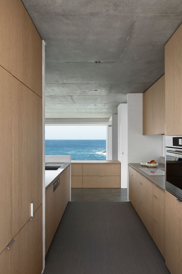 The simplicity of the galley-style kitchen promotes a sense of spaciousness and connection with the view.