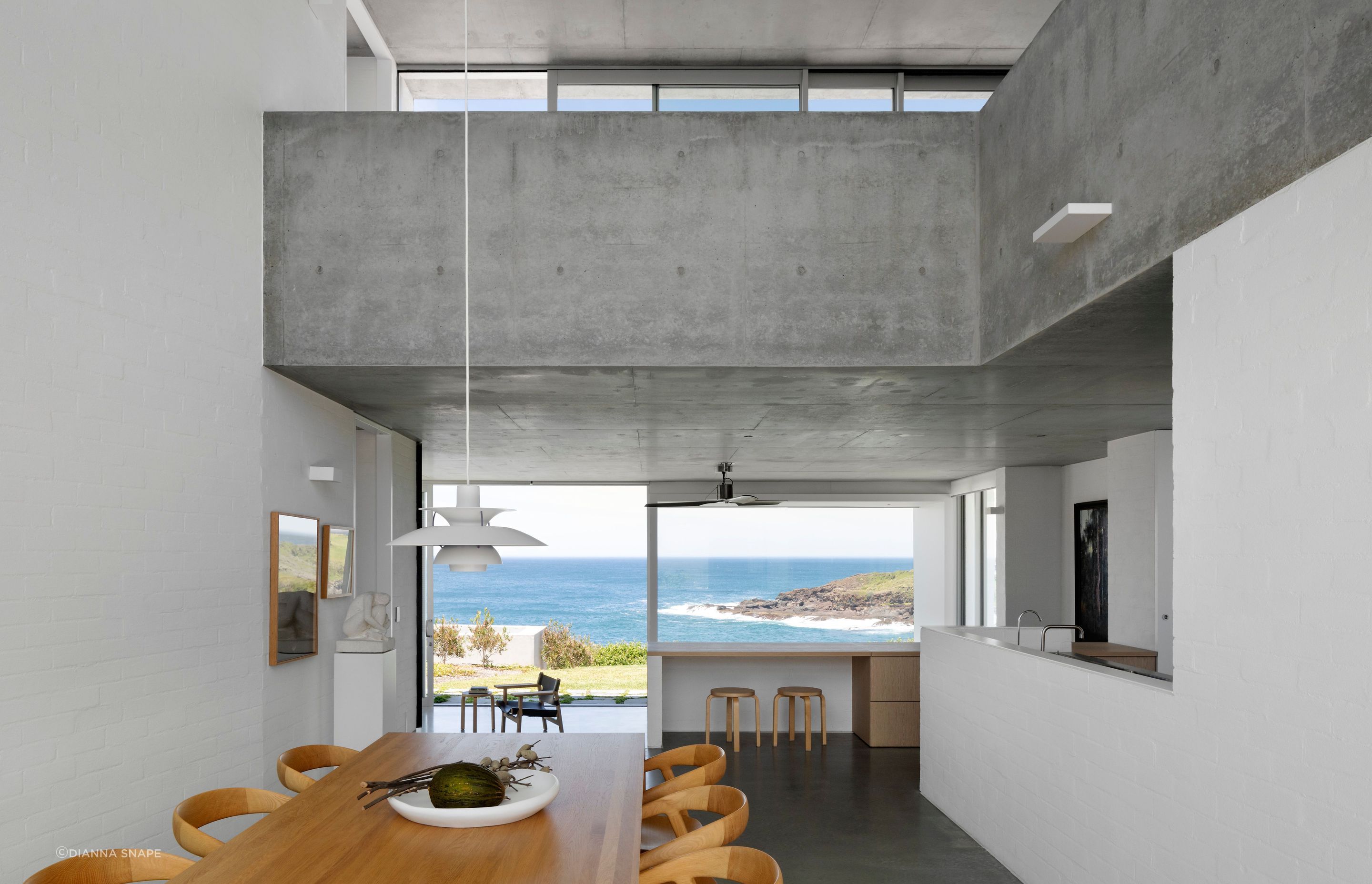 The living spaces enjoy a picture window view of the coast.