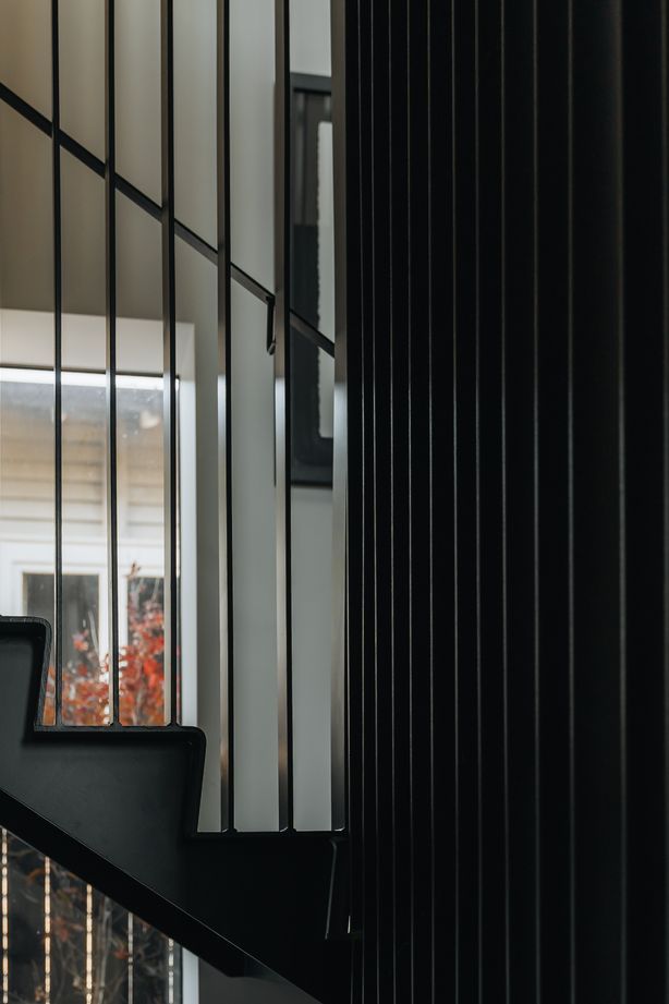 A batten steel balustrade welcomes natural light into the rest of the home.