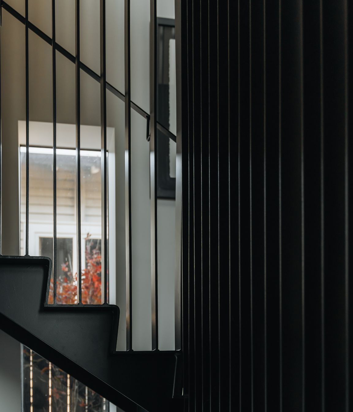 A batten steel balustrade welcomes natural light into the rest of the home.