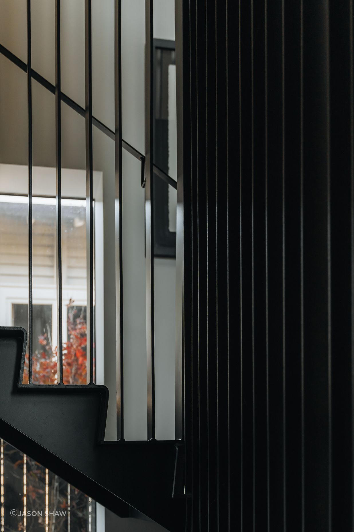 A batten steel balustrade welcomes natural light into the rest of the home.