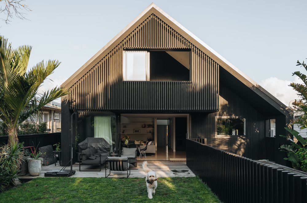 The backyard has grass for the children and family dog to enjoy, with a pool to the side.