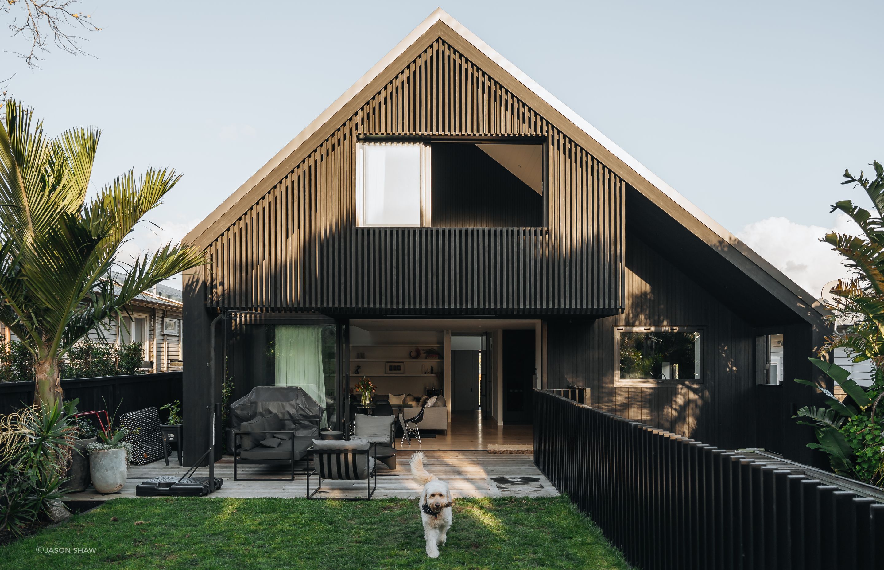 The backyard has grass for the children and family dog to enjoy, with a pool to the side.