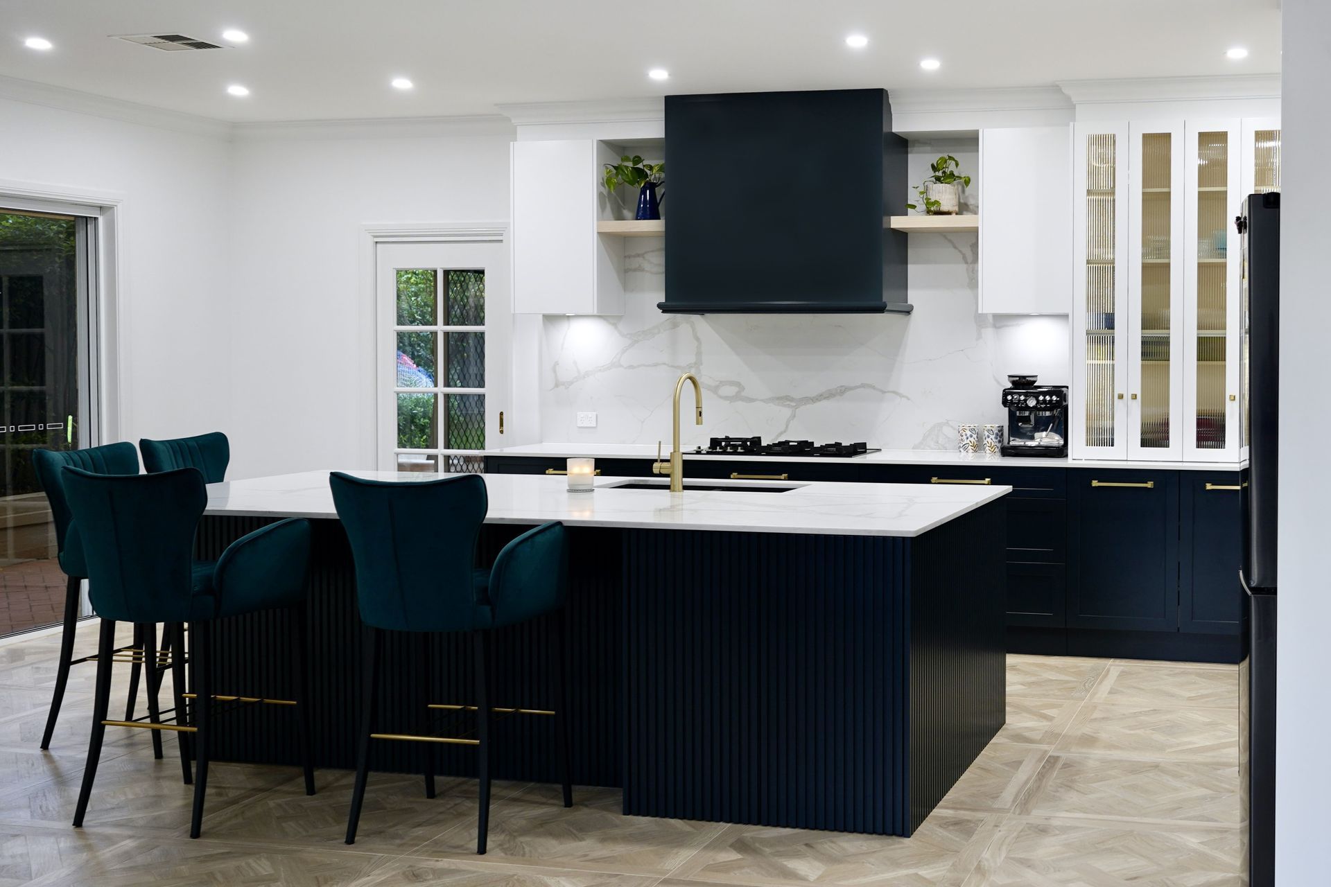 These Marina isles Metropolis handles and knobs in a brushed gold finish show how easily these accents can tie kitchen styling together