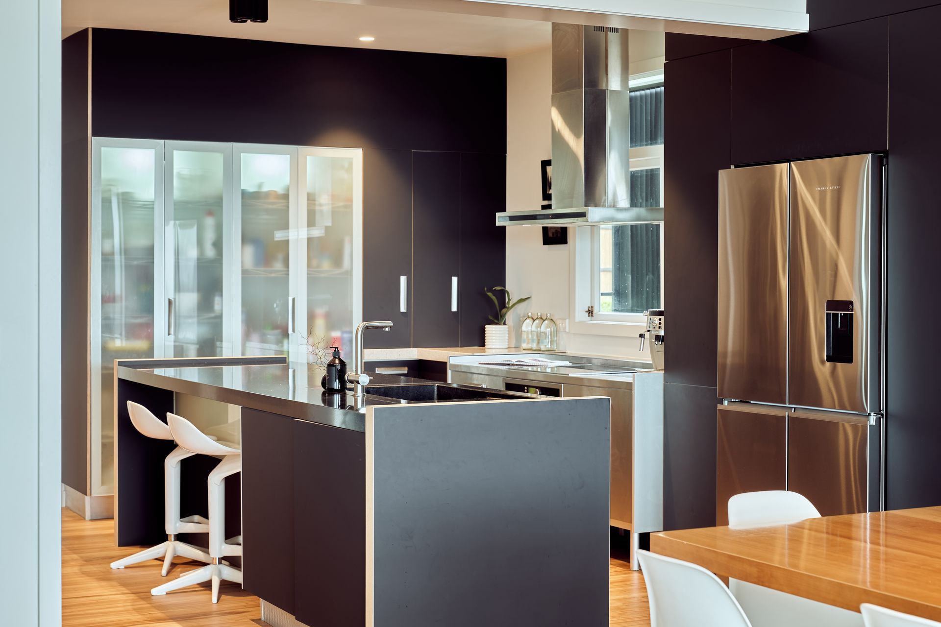 The dark, recessive kitchen is a show-stopping centrepiece.