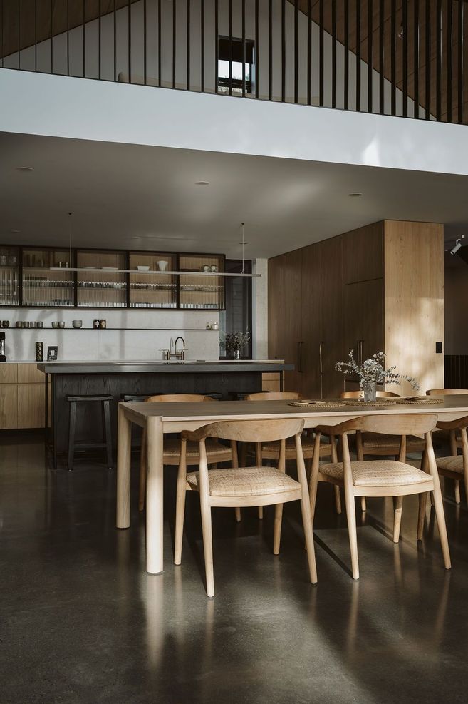 The kitchen was designed, manufactured and installed by Glen John Kitchens and features hardwood cabinetry with fluted glass, a dark stained island bench and an open-plan design that connects with the dining area.
