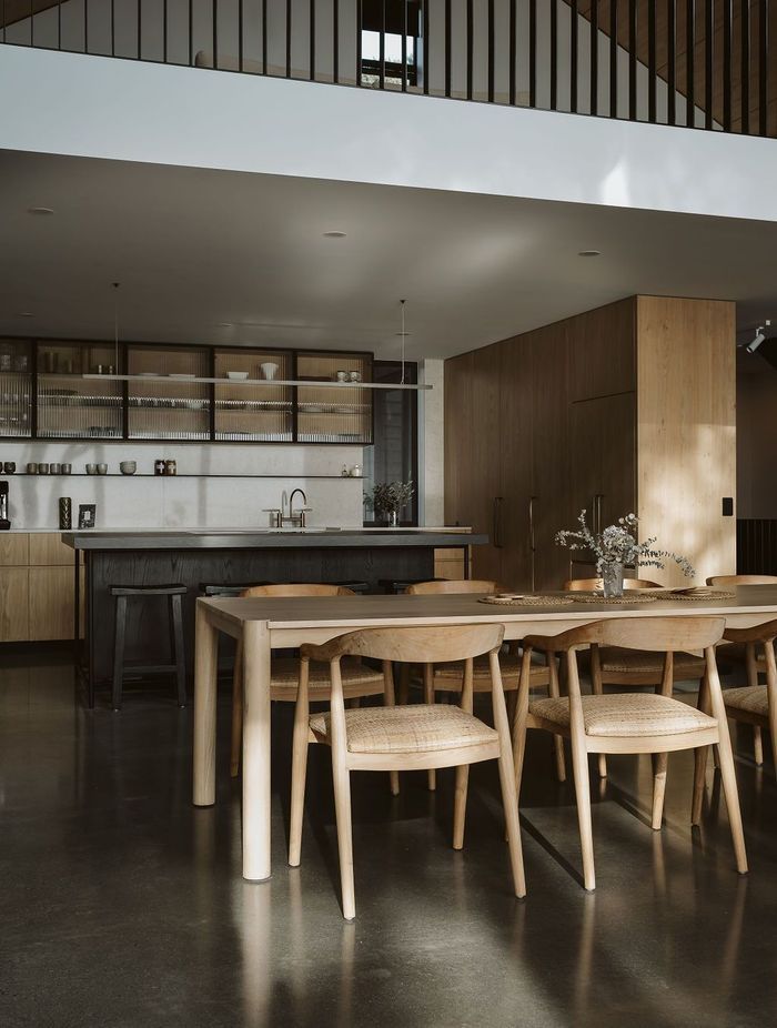 The kitchen was designed, manufactured and installed by Glen John Kitchens and features hardwood cabinetry with fluted glass, a dark stained island bench and an open-plan design that connects with the dining area.
