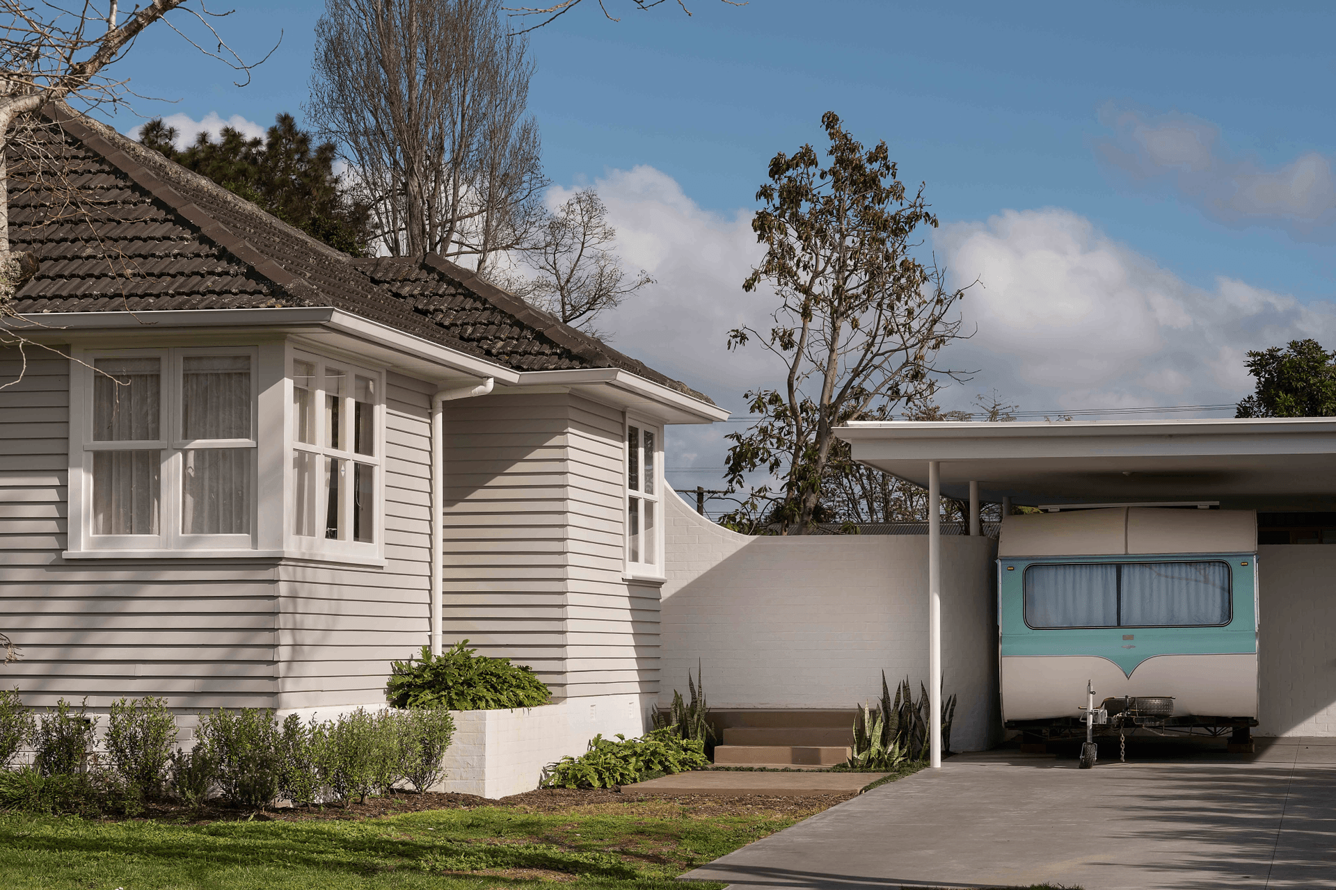The curved wall gives the backyard privacy and offers an intriguing architectural element.
