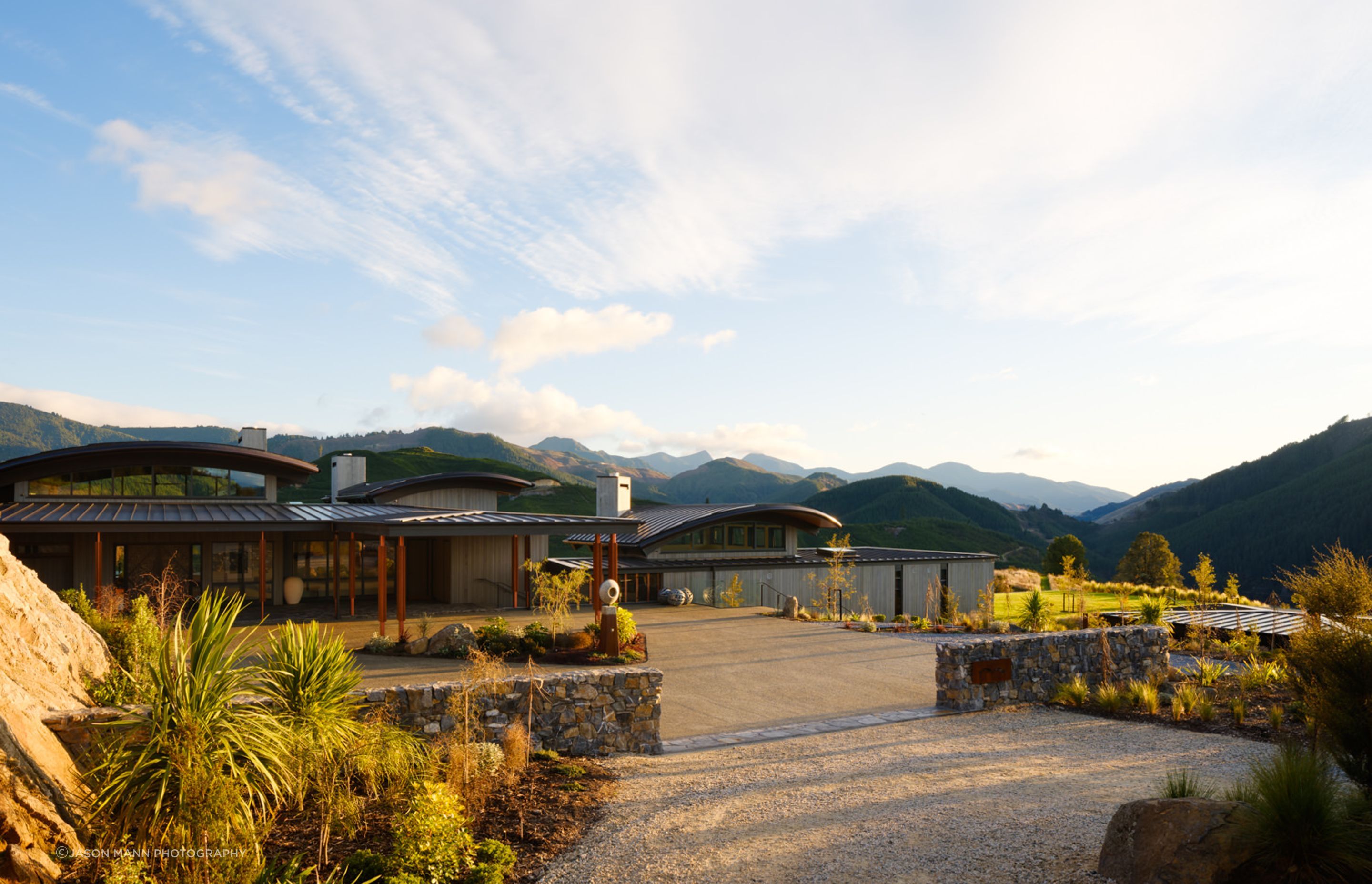 The entrance by road allows a slow reveal of the building. Simon says the entire complex is all off-grid. “It has quite a reasonable solar farm setting up the back, on the hill. It has its own generator, water and wastewater.”