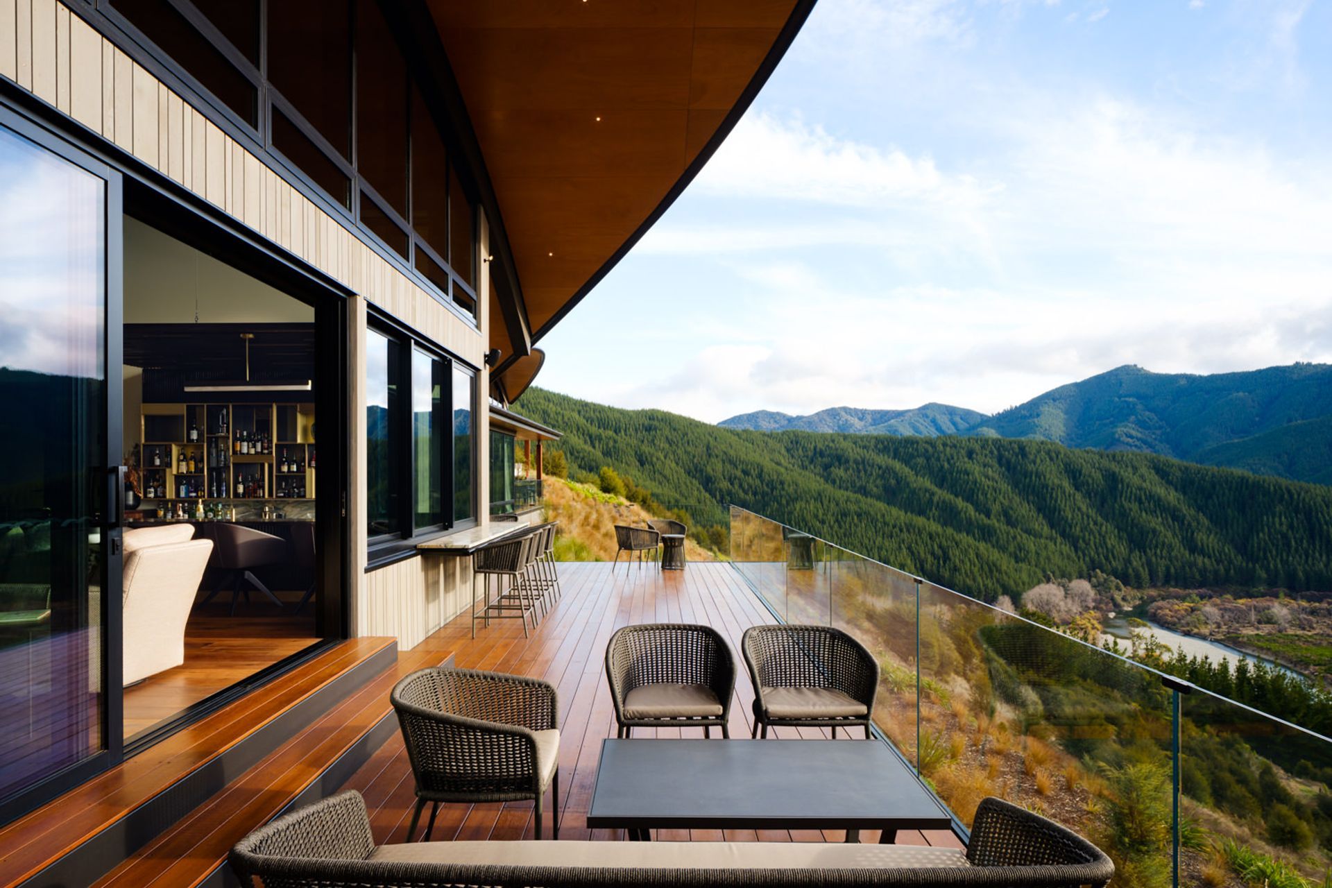 A deck off the bar area. The roofs give glimpses of mountains and rocky outcrops. “That gives you an idea of the building being more planted, and that you can actually see the native bush around you.”