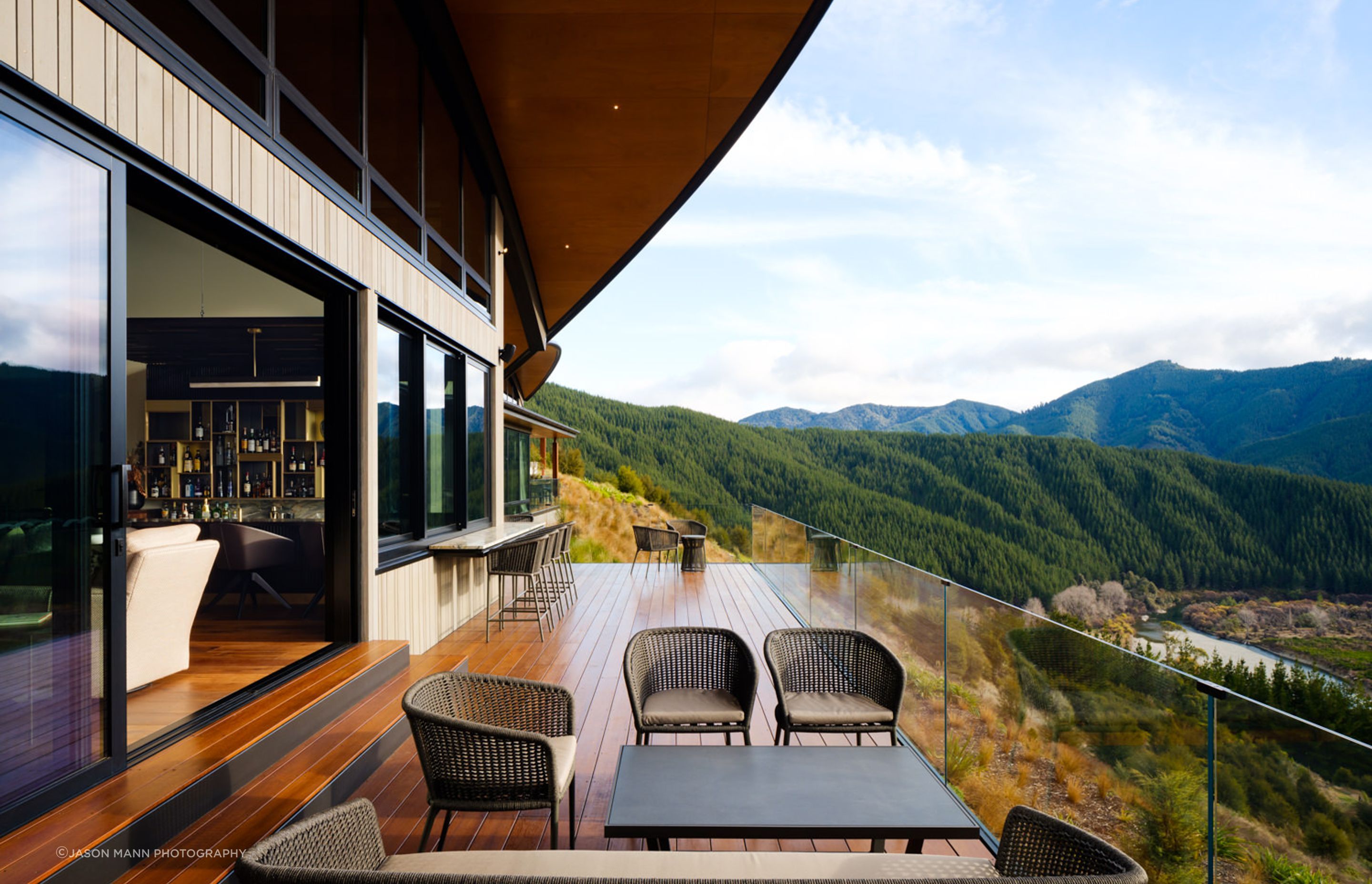 A deck off the bar area. The roofs give glimpses of mountains and rocky outcrops. “That gives you an idea of the building being more planted, and that you can actually see the native bush around you.”