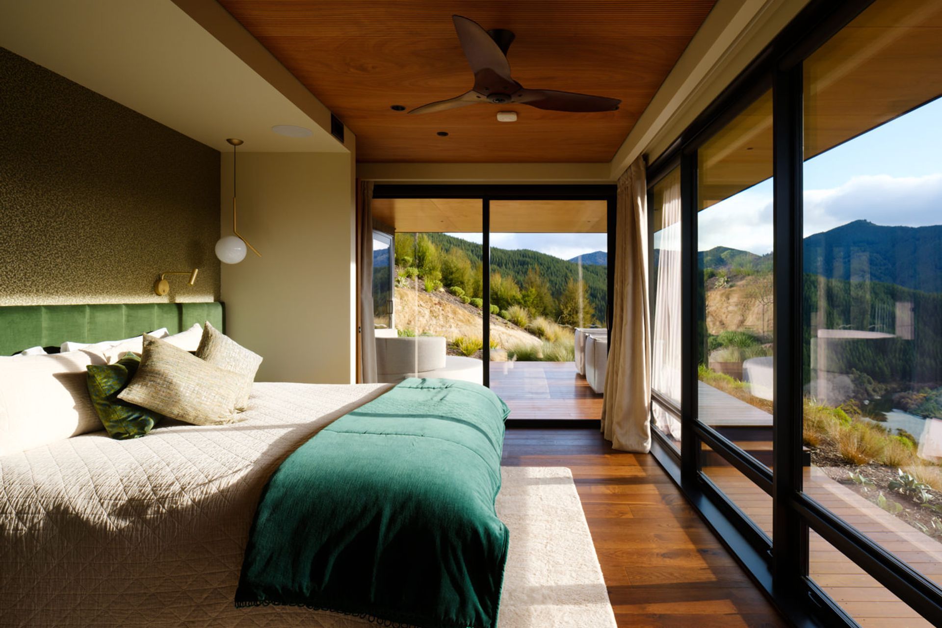 In this guest room, the IC pendant light is by Flos from ECC, the grasscloth wallpaper by Mark Alexander is from Seneca, the Smartfloor Marron Oak flooring is by Forté Flooring.