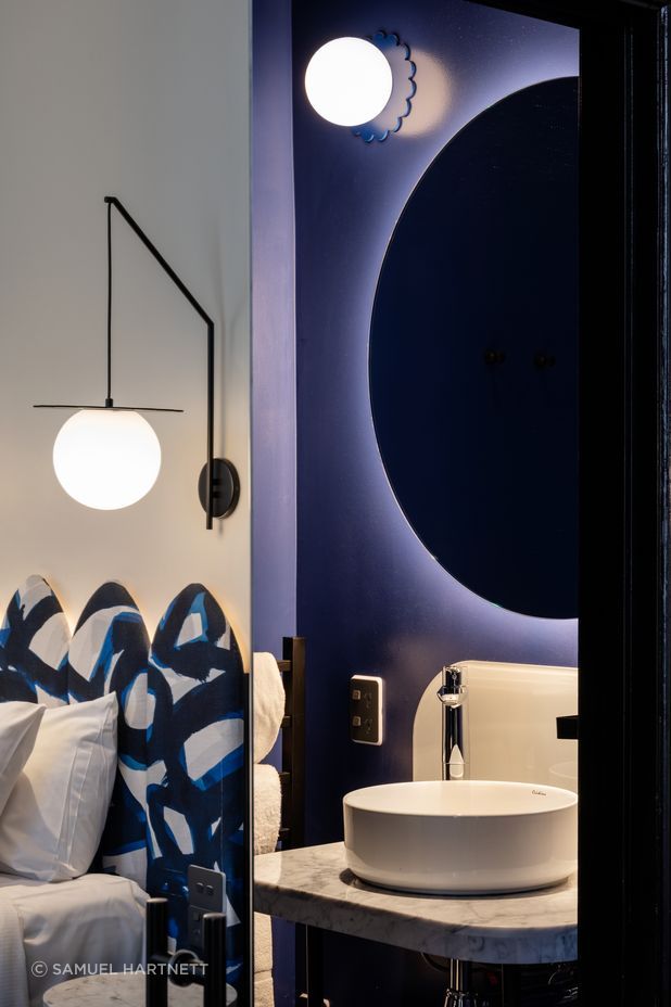 The bedhead fabric in the guest room is by James Dunlop. Every bathroom is in one of four different colourways.