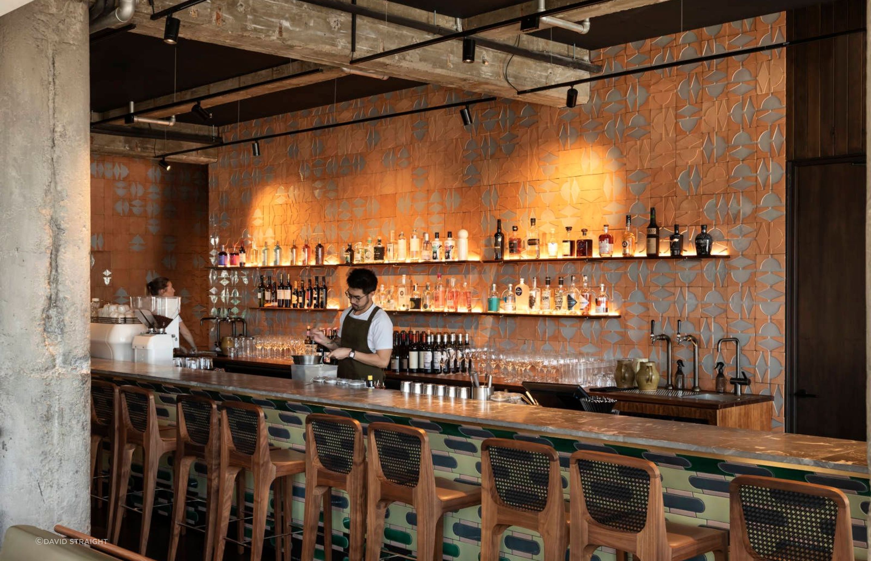 The combination of handmade tiles on the back wall, the bar and counter top allude to the artisan qualities of the food being served.