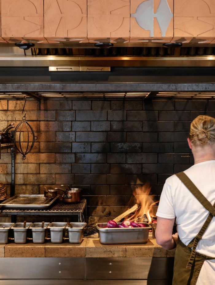 The kitchen is open to the dining space, allowing diners a chance to enjoy the performance of cooking.