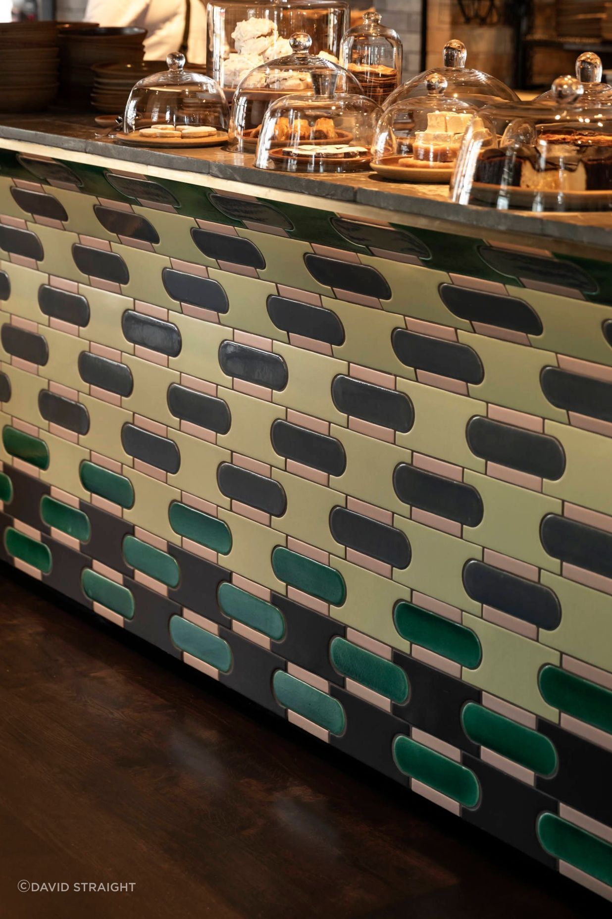 Colourful handmade tiles were chosen for the base of the bar counter and laid to accommodate a seamless pattern.