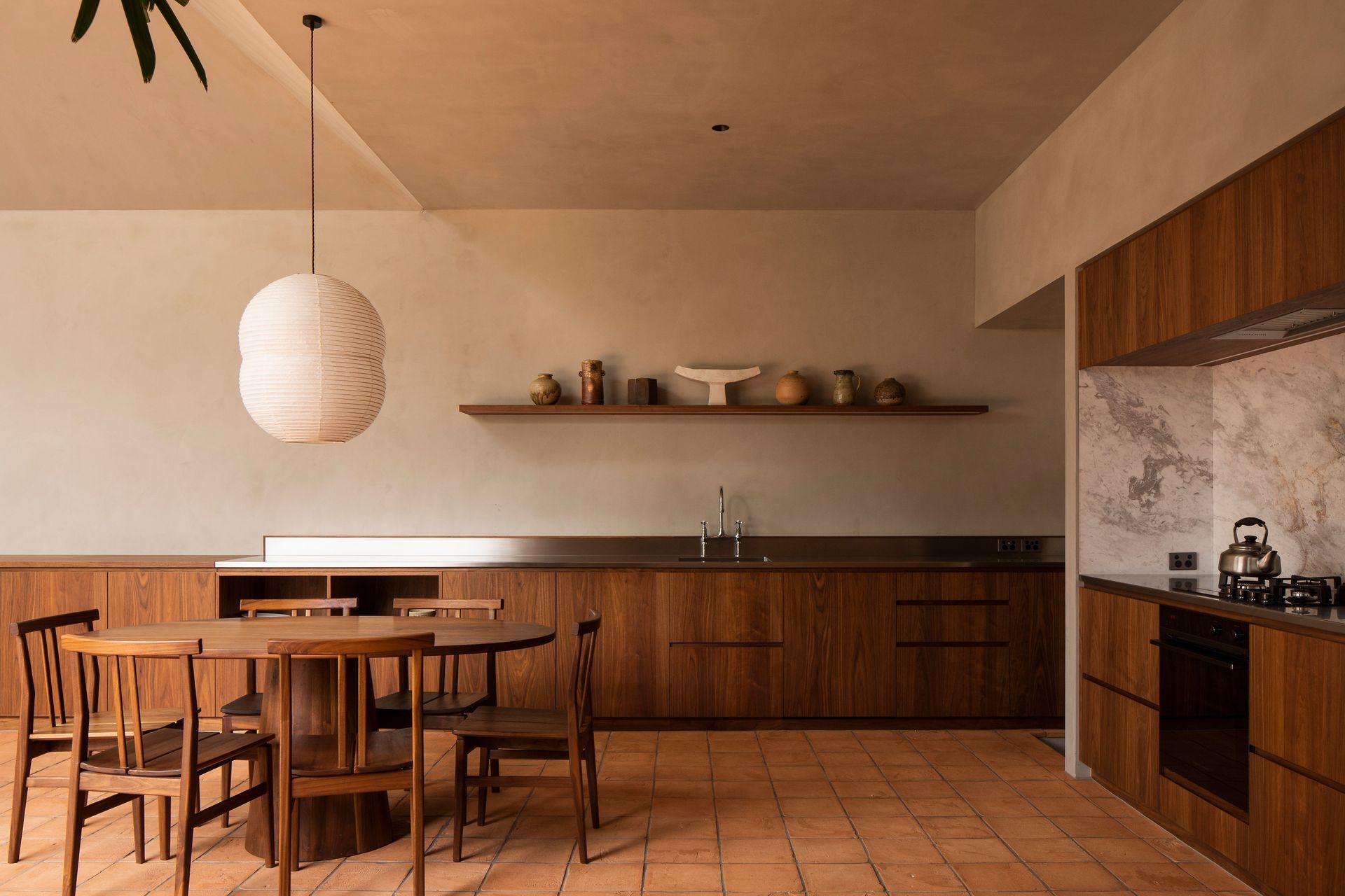 The kitchen area wraps around a corner of the extension. The walls are finished with Resene Rockcote Otsumigaki, a system in the tradition of lime and clay based Japanese plasters.