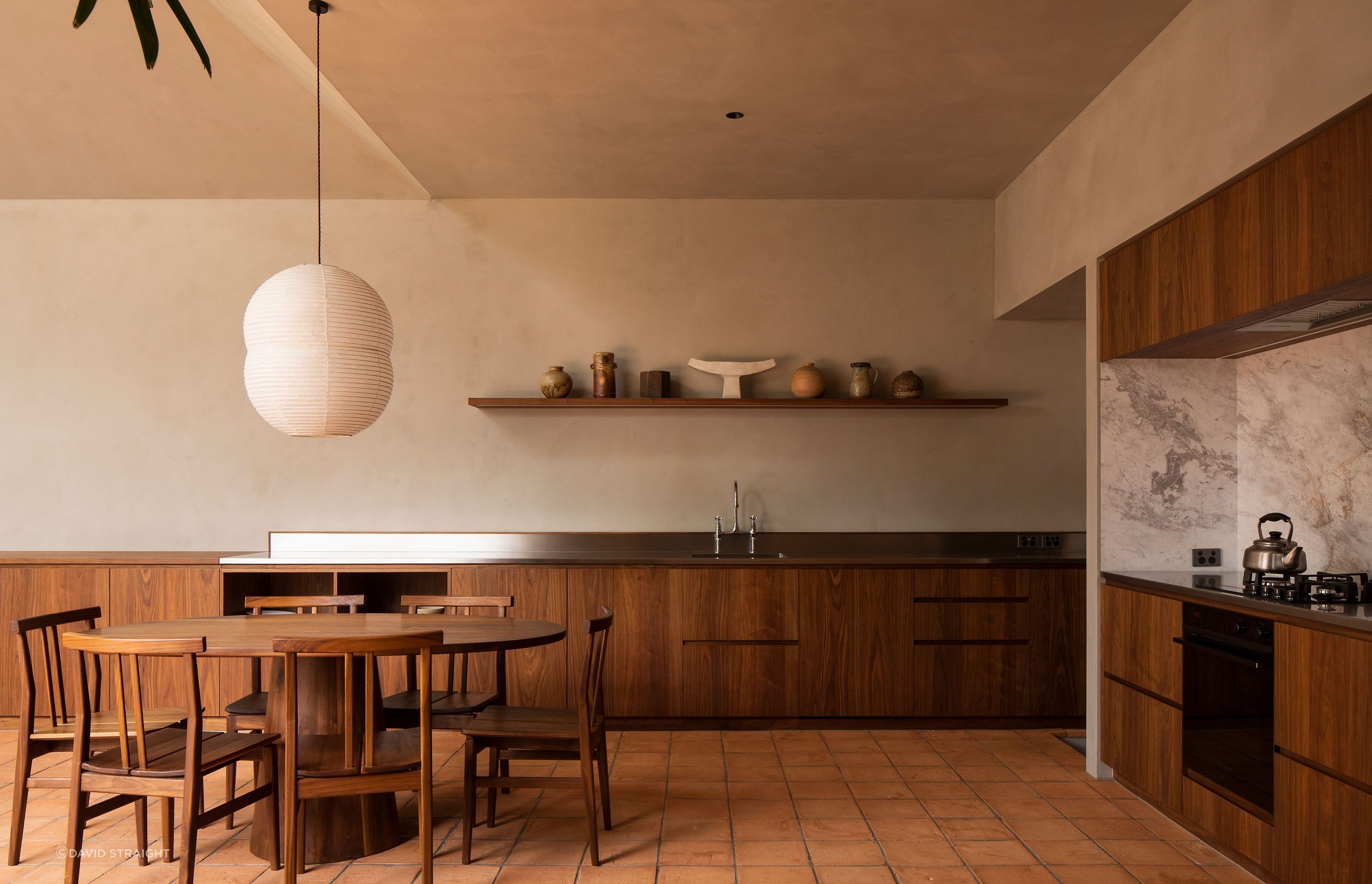 The kitchen area wraps around a corner of the extension. The walls are finished with Resene Rockcote Otsumigaki, a system in the tradition of lime and clay based Japanese plasters.