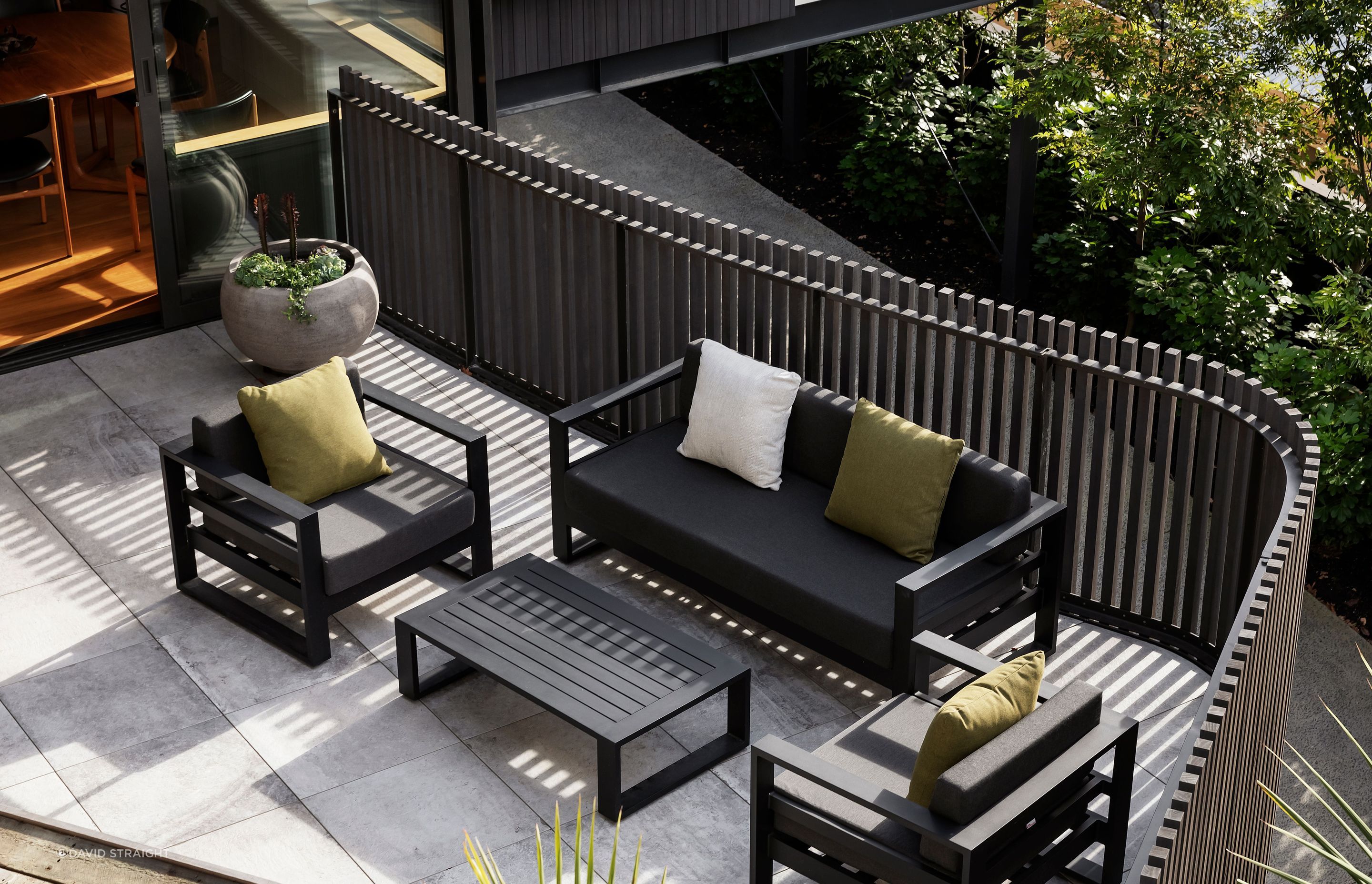 The morning terrace viewed from the elevated vegetable garden. The cladding and balustrades are eco-conscious Abodo wood. “You have a nice sense of containment when you're on the terrace, but with the ability to see through the gaps,” says Hamish.