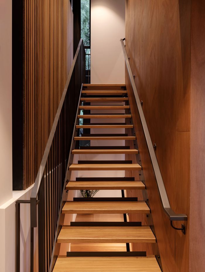 The open treads of the stairs to the main bedroom let light through. There is also a platform lift in the house: convenient now and for easier upstairs access if needed in the future.