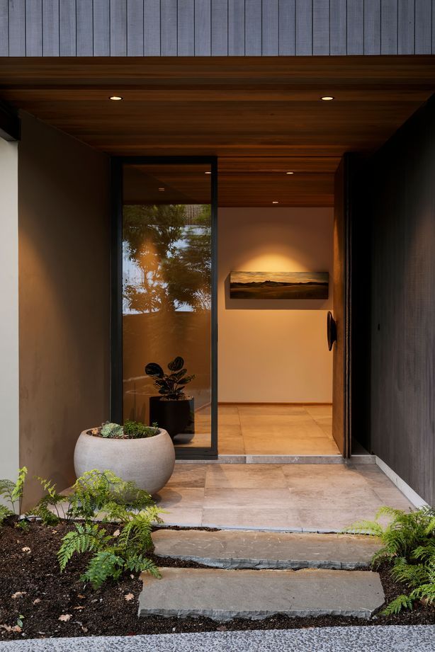 The main entrance features La Roche tiles from European Ceramics which look like polished concrete. This leads to a stairwell space which is compressed and releases you into the open living space on the level above.