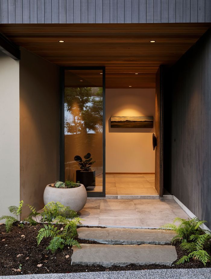The main entrance features La Roche tiles from European Ceramics which look like polished concrete. This leads to a stairwell space which is compressed and releases you into the open living space on the level above.