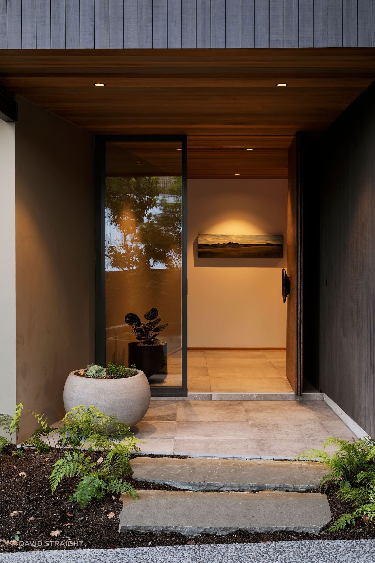 The main entrance features La Roche tiles from European Ceramics which look like polished concrete. This leads to a stairwell space which is compressed and releases you into the open living space on the level above.