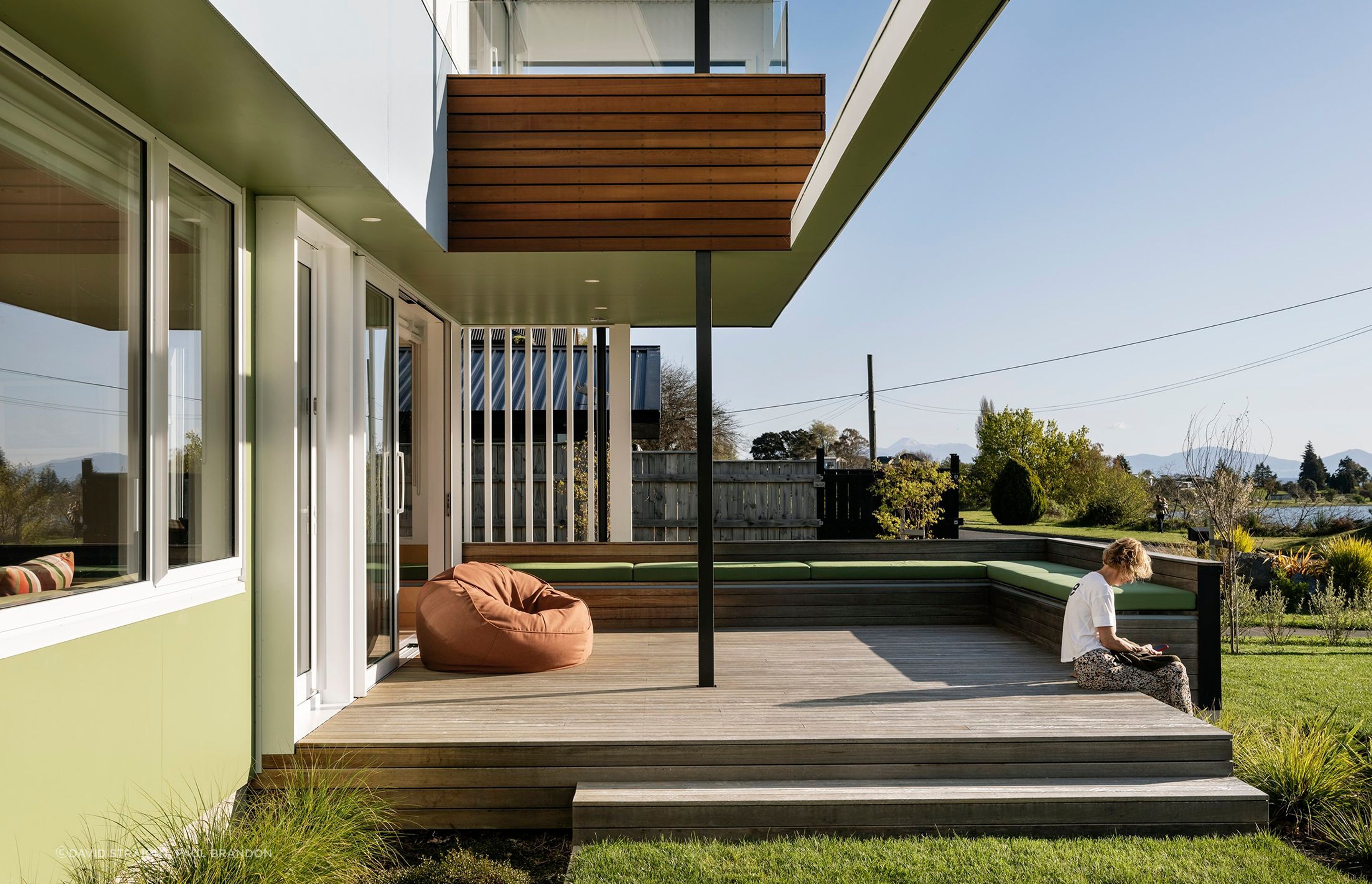 G House sits on a flat, slender site by Lake Taupō. Upon arrival, grass leads up to the garages; the first hint at the motif of relaxed, flowing spaces.