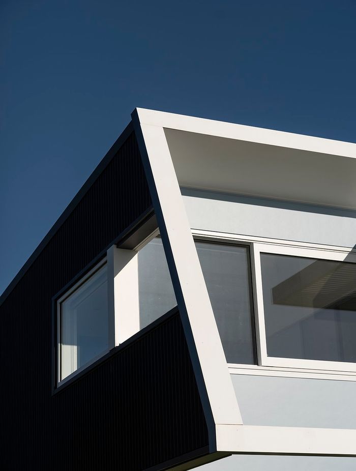 On the west, street-facing elevation, the second level protrudes over the downstairs with an elevated deck and pergola, creating shade and protection from the prevailing wind on both levels. 