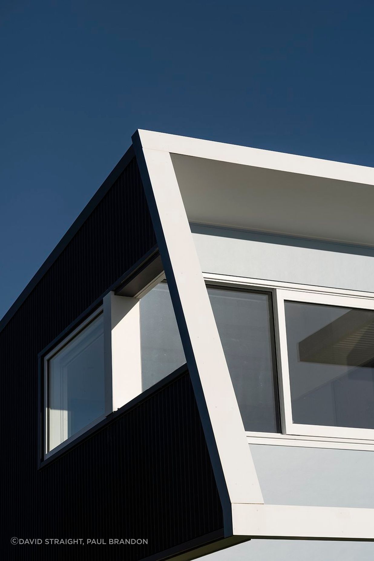 On the west, street-facing elevation, the second level protrudes over the downstairs with an elevated deck and pergola, creating shade and protection from the prevailing wind on both levels.